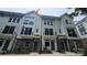 Stylish three-story townhome featuring gray accents, black railings, and covered front entries, with visible air conditioning units at 1421 Collier Walk Aly # Csw0209, Charlotte, NC 28205