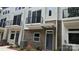 Modern townhome with brick facade, balcony, and well-maintained landscaping at 1421 Collier Walk Aly # Csw0209, Charlotte, NC 28205