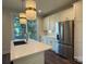 Modern kitchen island with white cabinets and a stylish gold faucet at 1421 Collier Walk Aly # Csw0209, Charlotte, NC 28205