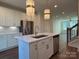 Open concept kitchen with island and stainless steel appliances at 1421 Collier Walk Aly # Csw0209, Charlotte, NC 28205