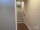 Modern staircase with hardwood flooring and neutral walls at 1421 Collier Walk Aly # Csw0209, Charlotte, NC 28205