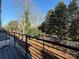 Balcony view overlooking a lush backyard with a glimpse of a pool at 1423 Collier Walk Aly # Csw0210, Charlotte, NC 28205
