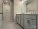 Modern bathroom with double vanity, large mirror and walk-in shower at 1423 Collier Walk Aly # Csw0210, Charlotte, NC 28205