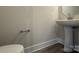 Modern bathroom with pedestal sink and hardwood floor at 1423 Collier Walk Aly # Csw0210, Charlotte, NC 28205