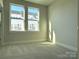 Well-lit bedroom featuring two windows and neutral walls at 1423 Collier Walk Aly # Csw0210, Charlotte, NC 28205