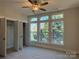 Bright bedroom with large windows, ceiling fan, and walk-in closet at 1423 Collier Walk Aly # Csw0210, Charlotte, NC 28205