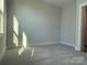 Sunlight filled bedroom with neutral walls and carpet at 1423 Collier Walk Aly # Csw0210, Charlotte, NC 28205