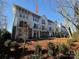Three-story townhome with white exterior and landscaping at 1423 Collier Walk Aly # Csw0210, Charlotte, NC 28205