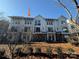 Modern three-story townhome with white siding and gray accents at 1423 Collier Walk Aly # Csw0210, Charlotte, NC 28205