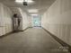 Unfinished garage with ample space and overhead lighting at 1423 Collier Walk Aly # Csw0210, Charlotte, NC 28205