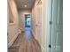Long hallway with wood-look flooring and access to bedrooms at 1423 Collier Walk Aly # Csw0210, Charlotte, NC 28205