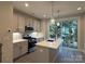 Modern kitchen features stainless steel appliances and an island at 1423 Collier Walk Aly # Csw0210, Charlotte, NC 28205