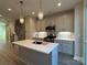 Modern kitchen with island, stainless steel appliances, and white cabinets at 1423 Collier Walk Aly # Csw0210, Charlotte, NC 28205