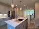 Open concept kitchen with island and stainless steel appliances at 1423 Collier Walk Aly # Csw0210, Charlotte, NC 28205