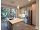 Modern kitchen with stainless steel appliances and an island at 1423 Collier Walk Aly # Csw0210, Charlotte, NC 28205