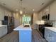 Modern kitchen with island, stainless steel appliances, and white cabinets at 1423 Collier Walk Aly # Csw0210, Charlotte, NC 28205