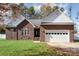 Brick home with white garage door and green lawn at 1009 Amber Ct, China Grove, NC 28023