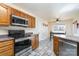 Spacious kitchen featuring stainless steel appliances and ample wood cabinetry at 1009 Amber Ct, China Grove, NC 28023