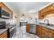 Eat-in kitchen with wood cabinets and modern appliances at 1009 Amber Ct, China Grove, NC 28023