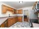 Bright kitchen with wood cabinets, tiled floor and stainless steel appliances at 1009 Amber Ct, China Grove, NC 28023