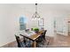 Dining room with farmhouse table, black chairs, and a chandelier at 1021 Freeman View Dr # 154P, Albemarle, NC 28001