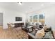 Living room with hardwood floors, neutral furniture, and a large window at 1021 Freeman View Dr # 154P, Albemarle, NC 28001