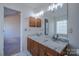 Bathroom features a dual sink vanity with granite countertops, a large mirror, and decorative lighting fixtures at 117 Eagle Ct, Mooresville, NC 28117