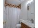 Bathroom featuring shower with patterned curtain and wooden vanity with marble countertop at 117 Eagle Ct, Mooresville, NC 28117