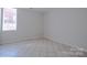 Neutral bedroom featuring tile floors, a window, and plenty of wall space at 117 Eagle Ct, Mooresville, NC 28117