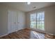 Bright bedroom with hardwood floors, a large window, and double closets at 117 Eagle Ct, Mooresville, NC 28117