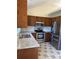 Kitchen featuring stainless steel appliances, granite countertops, wood cabinets, and tiled floors at 117 Eagle Ct, Mooresville, NC 28117