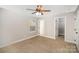 Bright bedroom offers plush carpeting, neutral paint, ceiling fan, and access to the walk-in closet at 1681 Evans Dr, Lancaster, SC 29720