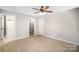 Spacious bedroom features neutral carpeting, a ceiling fan, and access to a walk-in closet and bath at 1681 Evans Dr, Lancaster, SC 29720