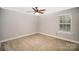 Cozy bedroom with a ceiling fan, a window, fresh paint, and plush carpet at 1681 Evans Dr, Lancaster, SC 29720