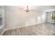 Bright dining area with modern vinyl floors, neutral paint, and a stylish chandelier at 1681 Evans Dr, Lancaster, SC 29720