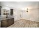 Bright kitchen area boasts modern finishes, stylish light fixture, and light wood-look flooring at 1681 Evans Dr, Lancaster, SC 29720