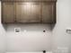 A bare laundry room with a utility hookup and upper cabinets at 1681 Evans Dr, Lancaster, SC 29720