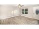 Bright living room with modern vinyl floors and a large window, providing natural light at 1681 Evans Dr, Lancaster, SC 29720