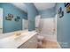 Updated bathroom with a shower/tub combo and blue walls at 2111 Priory Ct, Charlotte, NC 28262