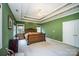 Large bedroom with green walls, ceiling fan, and ample closet space at 2111 Priory Ct, Charlotte, NC 28262