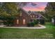 Brick two-story house with landscaped lawn and walkway at 2111 Priory Ct, Charlotte, NC 28262