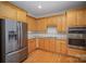 Modern kitchen with stainless steel appliances and light wood cabinets at 2111 Priory Ct, Charlotte, NC 28262