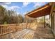 Spacious back deck with wooden railings, offering views of the backyard at 1176 Peppertree Dr, Mount Holly, NC 28120