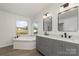 Bathroom boasts a soaking tub and double vanity at 1176 Peppertree Dr, Mount Holly, NC 28120