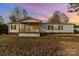 Single-story home with covered porch and landscaped yard at 1176 Peppertree Dr, Mount Holly, NC 28120