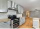 Updated kitchen with stainless steel range and hood at 1176 Peppertree Dr, Mount Holly, NC 28120