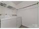 Laundry room with washer, dryer, and shelving at 1176 Peppertree Dr, Mount Holly, NC 28120