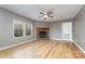 Living room with corner fireplace and hardwood floors at 1176 Peppertree Dr, Mount Holly, NC 28120