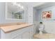 Clean bathroom with white vanity, beige countertop, and a large mirror at 138 Wyanoke Ave, Charlotte, NC 28205