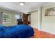 Bedroom with hardwood floors, window with backyard view, and access to another room at 138 Wyanoke Ave, Charlotte, NC 28205